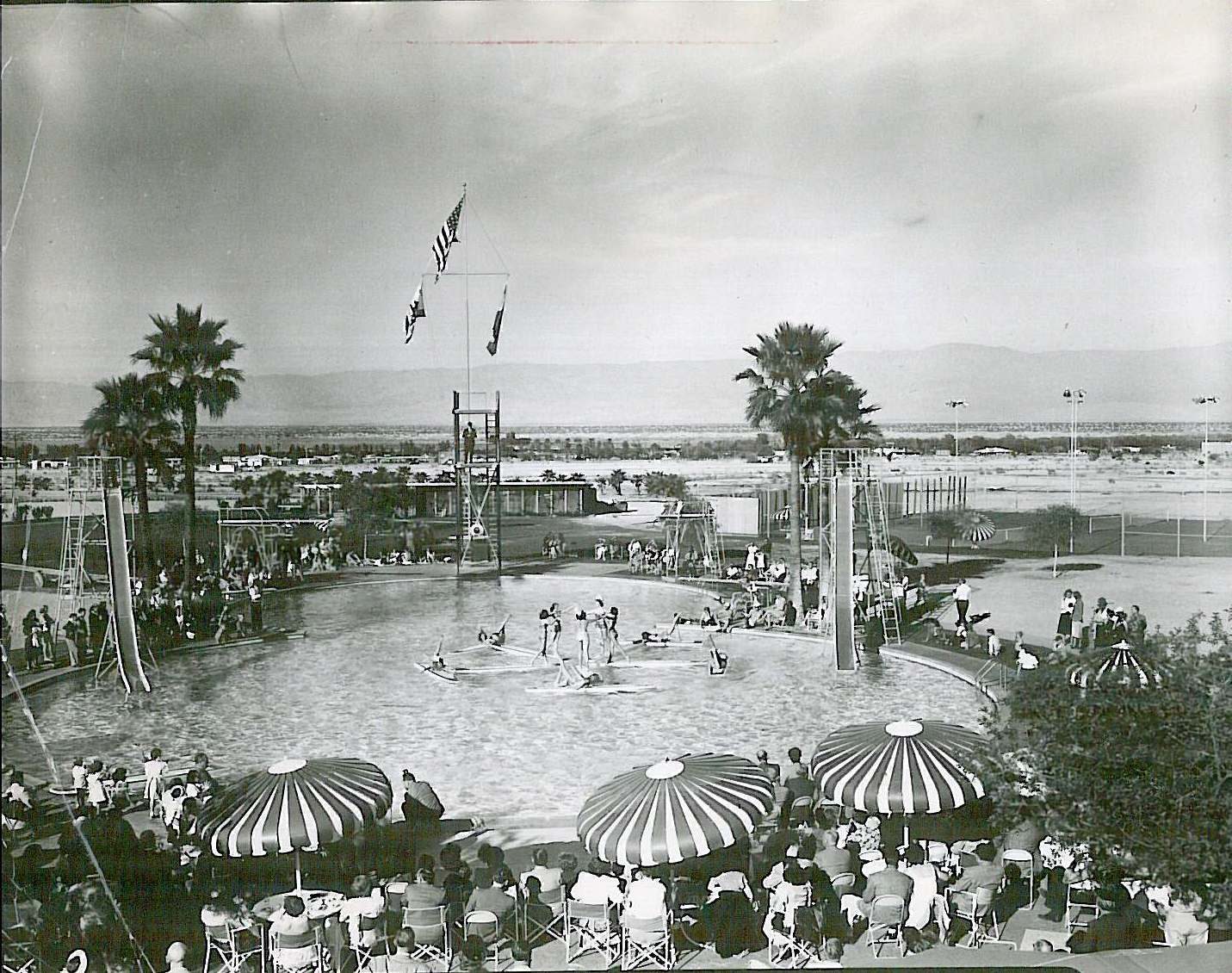 Poolside umbrellas and desert crowd